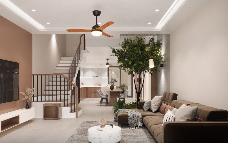 Phòng khách nhà ống thiết kế trần phẳng kết hợp sơn tường màu nâu mang lại không gian ấm cúng